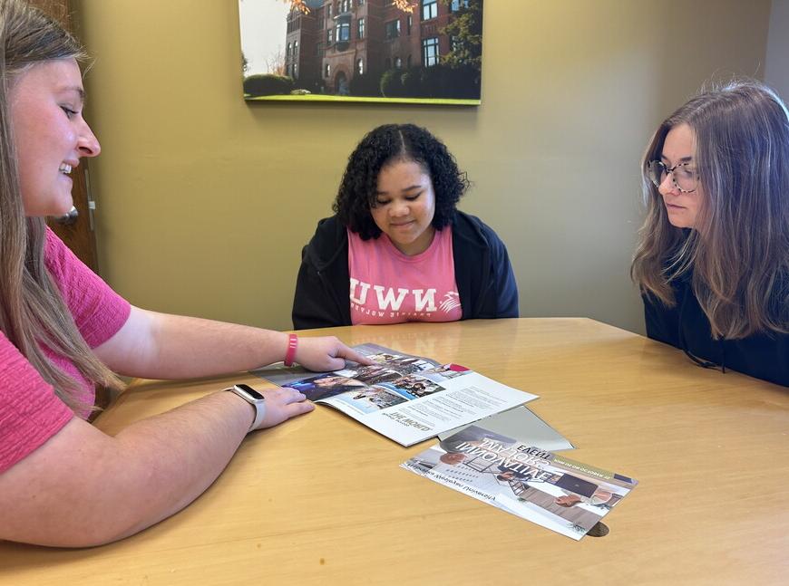 Students reviewing a book.